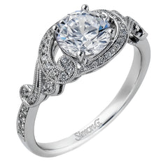 This lovely modern white gold engagement ring features a memorable halo and is accentuated by .19 ctw glistening round cut white diamonds.