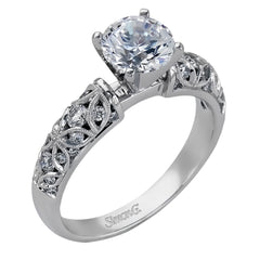 Featuring a delicate floral design, this white gold vintage engagement ring is set with .35 ctw of shimmering white diamonds.