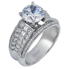 Presenting an eye-catching contemporary design, this white gold engagement ring features 1.31 ctw of princess cut white diamonds accented by .21 ctw of round cut white diamonds.