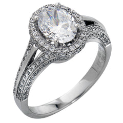 This lovely 18k white gold engagement ring design is created for an elegant oval center stone and features .77 ctw of white diamonds accented by a small touch of .03 ctw of yellow diamonds.