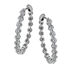 These elegant white gold hoops sparkle with .99 ctw of white diamonds