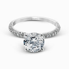 Presenting an eye-catching modern design, this white gold engagement ring and wedding band are highlighted by 1.45 ctw of round cut white diamonds.